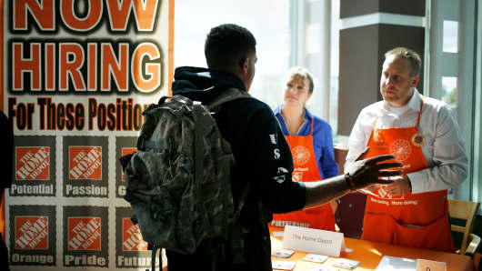 A job seeker speaks with recruiters from The Home Depot at a RecruitMilitary veterans job fair in Cleveland.