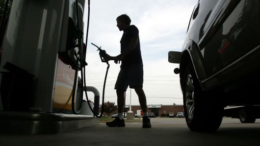 A driver returns the gas nozzle after filling his van at a station in Raleigh, N.C.