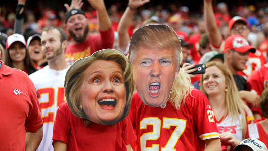 Hillary Clinton and Donald Trump masks worn by supporters.