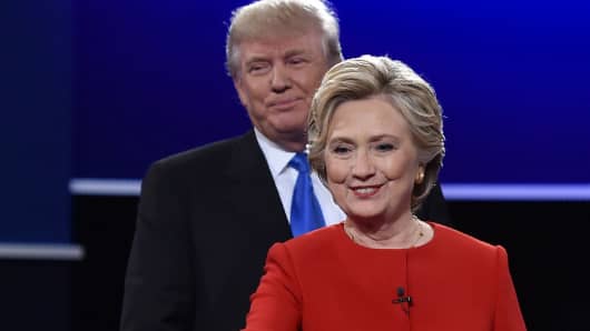 Democratic nominee Hillary Clinton, followed by Republican nominee Donald Trump, walk toward NBC moderator Lester Holt after the first presidential debate at Hofstra University in Hempstead, N.Y., on Sept. 26, 2016.
