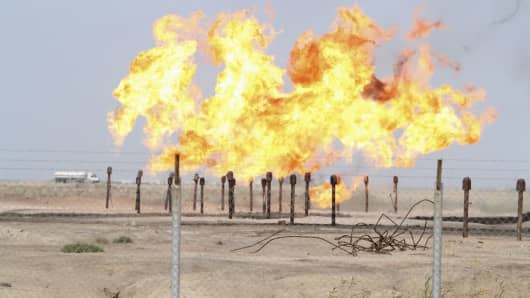 Excess gas is burnt off at a pipeline at Rumaila oilfield in Basra, Iraq.