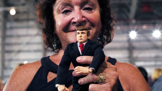 A supporter shows a doll depicting Republican presidential nominee Donald Trump during a campaign rally at the Orlando Melbourne International Airport in Melbourne, Florida.