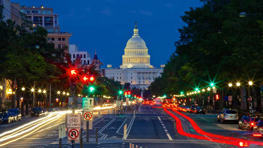 The United States Capitol Building as viewed with traffic from Pennsylvania Avenue.