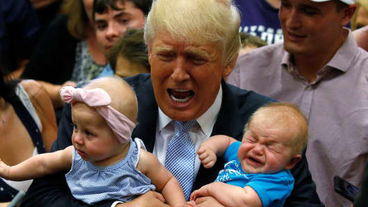 Republican presidential nominee Donald Trump holds babies at a campaign rally in Colorado Springs, Colorado, U.S., July 29, 2016.