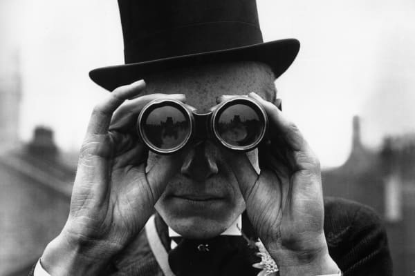 Man in top hat with binoculars, wealth