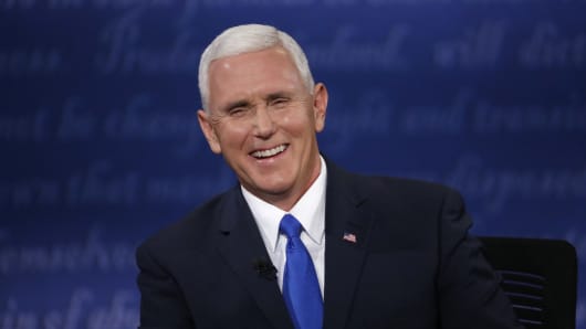 Republican U.S. vice presidential nominee Governor Mike Pence laughs as he discusses an issue with Democratic U.S. vice presidential nominee Senator Tim Kaine (off camera) during their vice presidential debate at Longwood University in Farmville, Virginia, U.S., October 4, 2016.