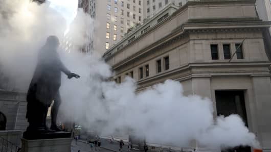 The George Washington statue in front of Federal Hall on Wall Street is engulfed in a cloud of steam.
