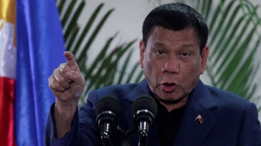 Philippine President Rodrigo Duterte interacts with reporters during a news conference upon his arrival from a four-day state visit in China at the Davao International Airport in Davao city, Philippines October 21, 2016.