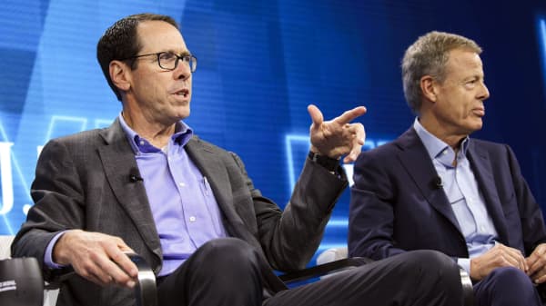 Randall Stephenson, chairman and chief executive officer of AT&T, left, speaks while Jeffrey Bewkes, chairman and chief executive officer of Time Warner, listens during a conference in Laguna Beach, California, October 25, 2016.