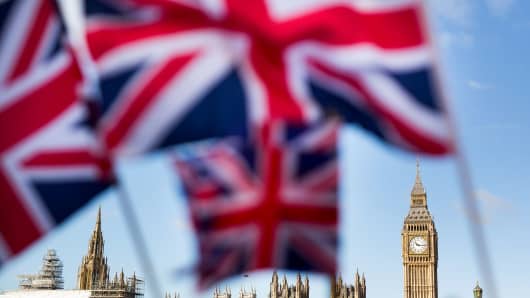 A display of U.K., Union Jack flags fly in front of The Houses of Parliament, in London, U.K., on Monday, Feb. 15, 2016.