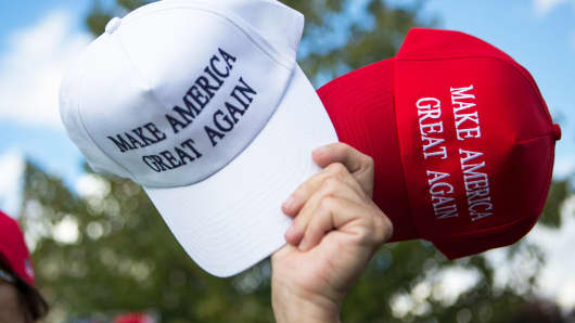 A vendor sells hats to supporters before a campaign rally for Republican presidential nominee Donald Trump on October 21, 2016 in Newtown, Pennsylvania.