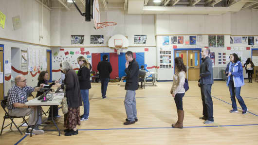 Voters on line in a school gym