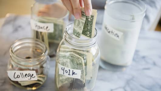 Woman saving money in jars