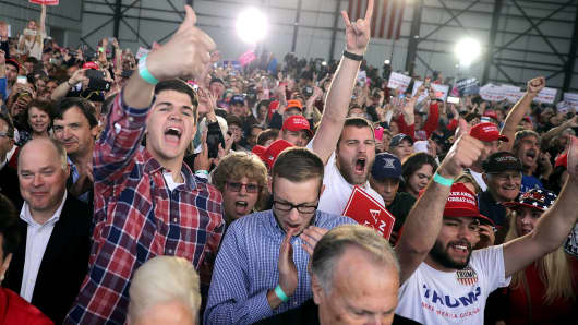 Supporters cheer for Donald Trump during a campaign rally at the Airborne Maintenance & Engineering Services hanger November 4, 2016 in Wilmington, Ohio.