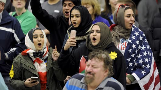 Young Muslims protest U.S. Republican presidential candidate Donald Trump before being escorted out during a campaign rally in the Kansas Republican Caucus at the Century II Convention and Entertainment Center in Wichita, Kansas March 5, 2016.