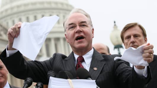 Rep. Tom Price, R-Ga., tears a page from the national health-care bill during a press conference at the U.S. Capitol on March 21, 2012, in Washington, DC.