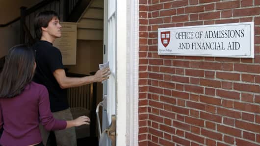 Students enter the Admissions Building on the campus of Harvard University.