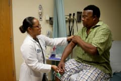 An insured patient under the Affordable Care Act receives a checkup at the South Broward Community Health Services clinic in Hollywood, Florida.
