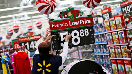 A Walmart worker organizes products for Christmas season at a Walmart store in Teterboro, New Jersey.