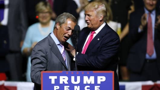 Donald Trump, right, greets United Kingdom Independence Party leader Nigel Farage during a campaign rally at the Mississippi Coliseum on August 24, 2016 in Jackson, Mississippi.