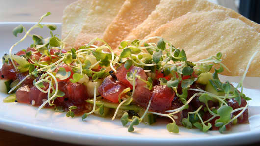 The yellowfin ahi tuna poke, with cucumber, snap peas, poke sauce, sesame, scallions, and wonton at the Blue Island Oyster Bar a new seafood addition to Denver restaurants on Thursday, November 12, 2015.