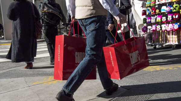 A shopper carries Gump's shopping bags in San Francisco.