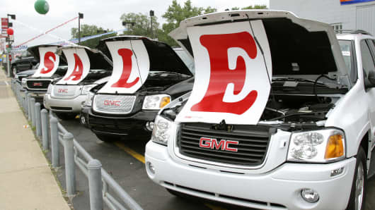 Sale signs lie on vehicles at a General Motors Chevrolet dealership in Ferndale, Michigan.
