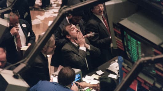 A trader (c) on the New York Stock Exchange looks at stock rates 19 October 1987 as stocks were devastated during one of the most frantic days in the exchange's history.
