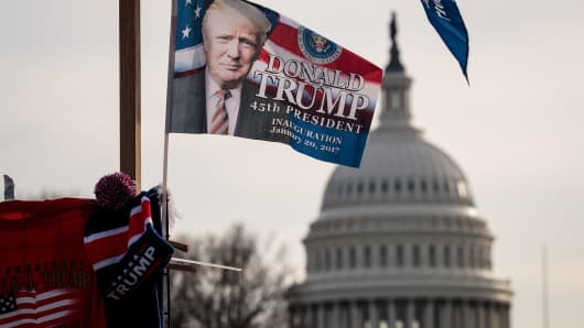 With the U.S. Capitol in the background, 'Trump' flags fly on top of a merchandise stand on North Capitol Street