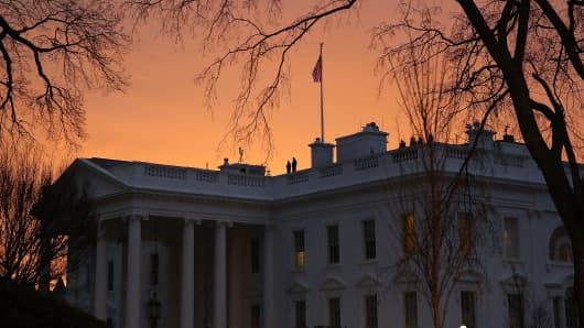 The early morning sun begins to rise behind the White House, on January 20, 2017 in Washington, DC.