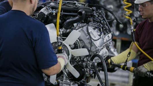 Workers complete a truck's engine on the assembly line at the Toyota Motor Corp. manufacturing facility in San Antonio, Texas