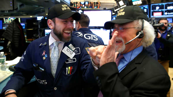 Traders celebrate on the main trading floor of the New York Stock Exchange (NYSE) as the Dow Jones Industrial Average passes the 20,000 mark shortly after the opening of the trading session in New York, U.S., January 25, 2017.