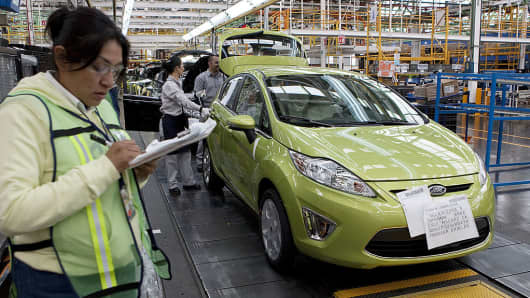 Employees work on the assembly line producing the new Ford Fiesta car, at the Ford Motor Co. plant in Cuautitlan Izcalli, Mexico