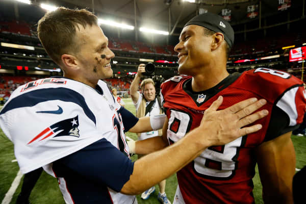 Tom Brady #12 of the New England Patriots and Tony Gonzalez #88 formerly of the Atlanta Falcons.