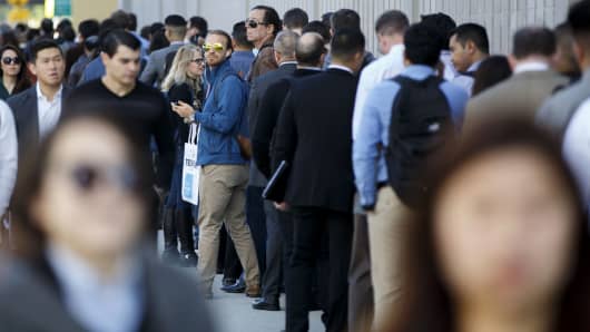 Job seekers wait in line during the TechFair LA job fair in Los Angeles, California.