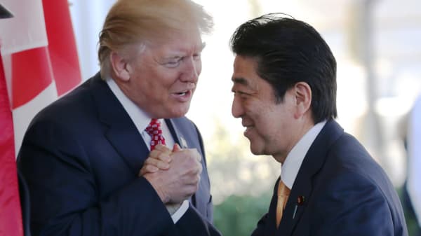 President Donald Trump (L) greets Japanese Prime Minister Shinzo Abe as he arrives at the White House on February 10, 2017 in Washington, DC.