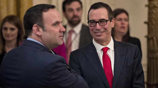 Steven Mnuchin, Treasury secretary nominee for U.S. President Donald Trump (R) attends a swearing in ceremony of White House senior staff in the East Room of the White House on January 22, 2017 in Washington, DC.