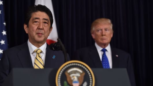 Japanese Prime Minister Shinzo Abe (L) and US President Donald Trump speak at Trump's Mar-a-Lago resort in Palm Beach, Florida, on February 11, 2017.
