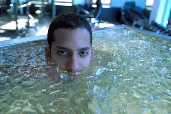 Magician, David Blaine soaks in a water bath full of ice.