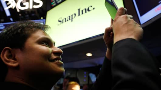 Snap Inc. chief strategy officer, Imran Khan, takes a photograph on the floor of the New York Stock Exchange (NYSE) while waiting for Snap Inc. to post their IPO in New York, U.S., March 2, 2017.