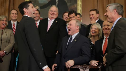 Speaker of the House Paul Ryan (R-WI) (3rd L) shares a laugh with Republican members of Congress after signing legislation to repeal the Affordable Care Act, also known as Obamacare, and to cut off federal funding of Planned Parenthood during an enrollment ceremony in the Rayburn Room at the U.S. Capitol in Washington, DC.