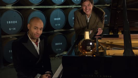 Diehl and Lumsden at the piano, surrounded by casks of whisky and a special bottle of Pride 1974.