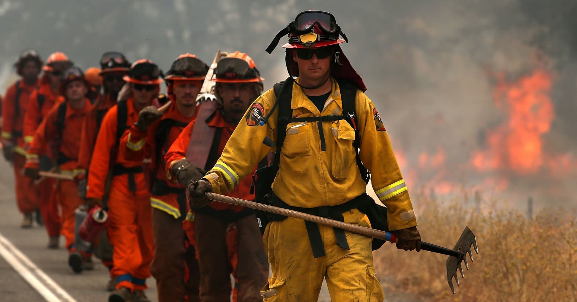 A Cal Fire firefighter leads a group of firefighters during a burn operation.