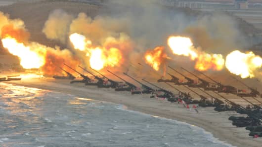 Artillery pieces are seen being fired during a military drill at an unknown location, in this undated photo released by North Korea's Korean Central News Agency (KCNA) on March 25, 2016.