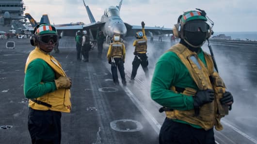 Sailors conduct flight operations on the aircraft carrier USS Carl Vinson (CVN 70) flight deck in the South China Sea