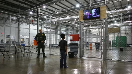 A boy from Honduras watches a movie at a detention facility run by the U.S. Border Patrol on September 8, 2014 in McAllen, Texas.