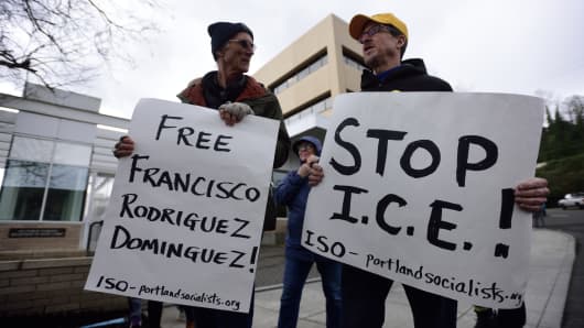 Two men hold banners reading 'Free Francisco Rodriguez Dominguez - Stop I.C.E' during a protest outside the Immigration and Customs Enforcement (ICE) building in Portland, Oregon, United States, on March 28, 2017.