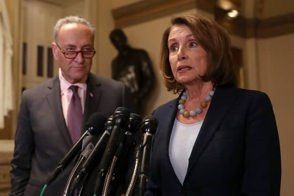 Senate Minority Leader Charles Schumer (L) ,D-N.Y., looks on as House Minority Leader Nancy Pelosi, D-Calif., speaks to reporters during a news conference at the U.S. Capitol in Washington.