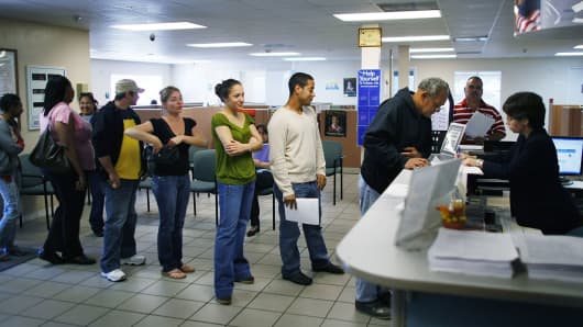 Job seekers stand in line at the employment help center in Miami, Florida. 