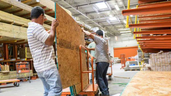 Shoppers selecting plywood in a Home Depot store in Miami.